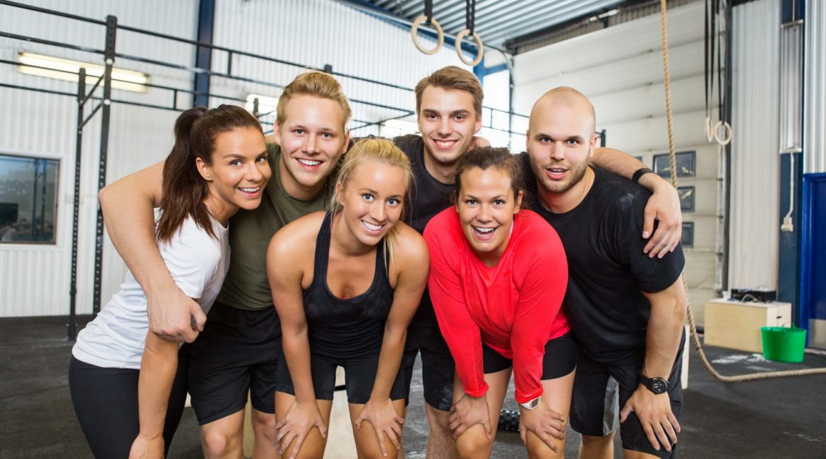Group Of Happy Athletes Standing At cross fitness box